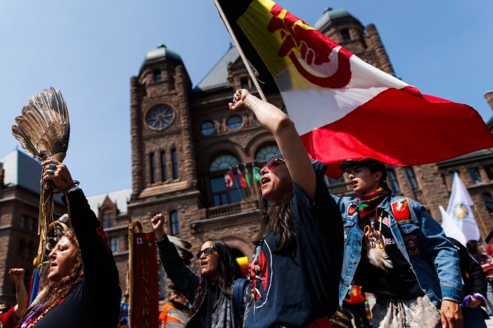 Protesters chant and wave flags during a demonstration outside the Ontario Legislature at Queen's Park in Toronto, Monday, June 2, 2025. THE CANADIAN PRESS/Cole Burston