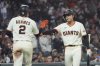 San Francisco Giants' Willy Adames (2) is congratulated by Jung Hoo Lee after scoring against the Philadelphia Phillies during the eighth inning of a baseball game in San Francisco, Monday, July 7, 2025. (AP Photo/Jeff Chiu)