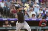 Arizona Diamondbacks' Eugenio Suárez follows the flight of his solo home run off Colorado Rockies starting pitcher Carson Palmquist in the third inning of a baseball game Saturday, June 21, 2025, in Denver. (AP Photo/David Zalubowski)