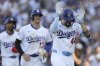 Los Angeles Dodgers' Andy Pages (44) celebrates with sunflower seeds after hitting a home run as designated hitter Shohei Ohtani (17) reacts during the fifth inning of a baseball game against the San Francisco Giants in Los Angeles, Sunday, June 15, 2025. (AP Photo/Jessie Alcheh)