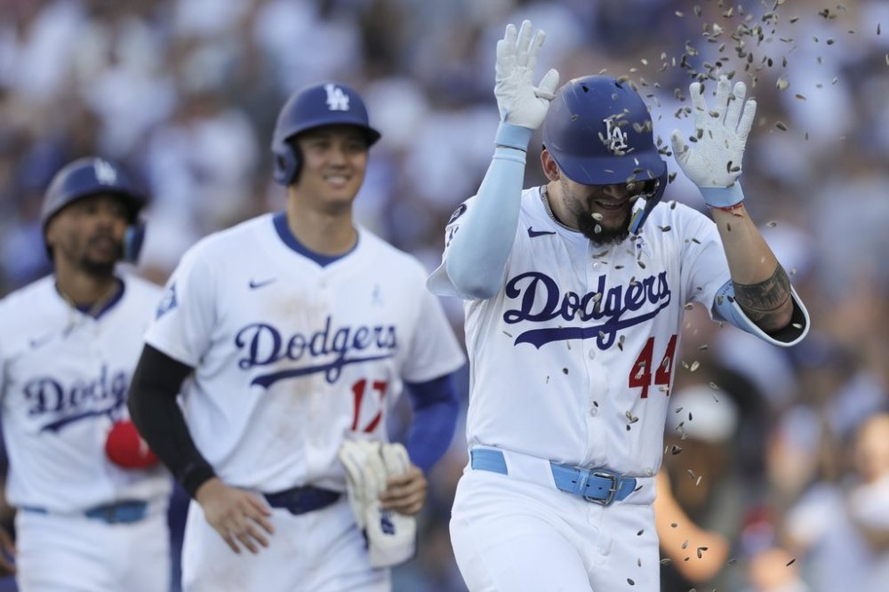 Los Angeles Dodgers' Andy Pages (44) celebrates with sunflower seeds after hitting a home run as designated hitter Shohei Ohtani (17) reacts during the fifth inning of a baseball game against the San Francisco Giants in Los Angeles, Sunday, June 15, 2025. (AP Photo/Jessie Alcheh)