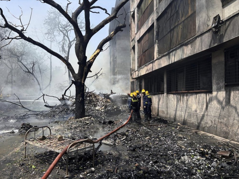 Firefighters work at the site of an airplane that crashed in India's northwestern city of Ahmedabad in Gujarat state, Thursday, June12, 2025. (AP Photo/Ajit Solanki)