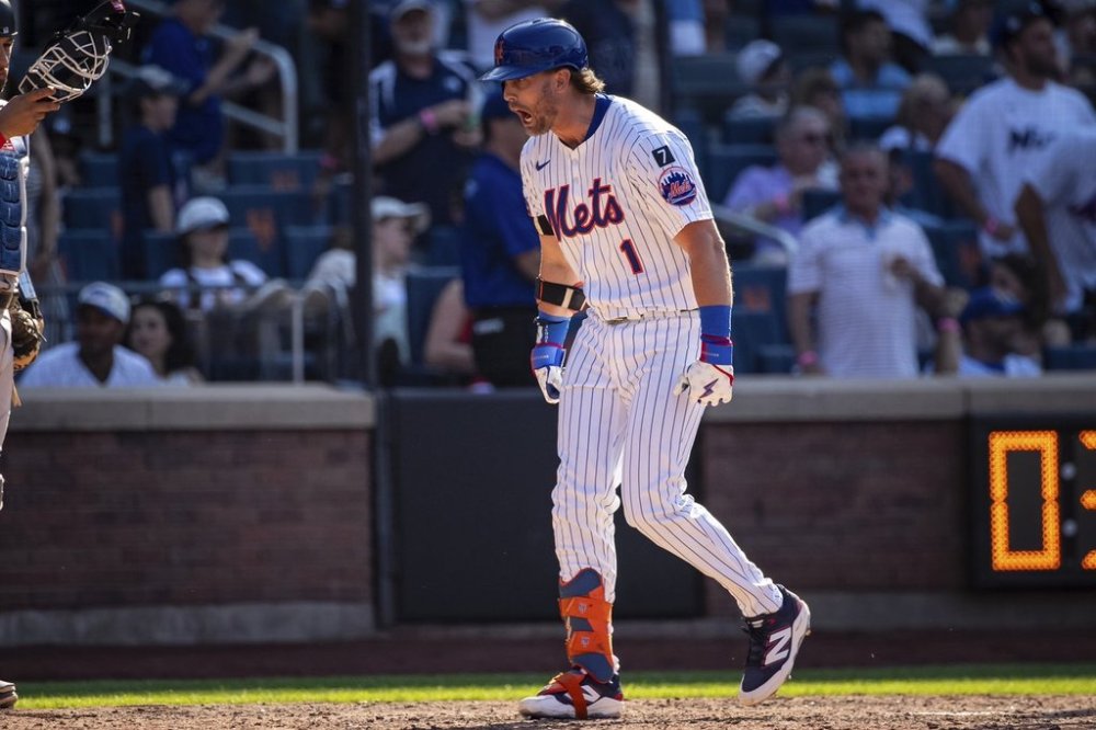 New York Mets' Jeff McNeil celebrates after scoring on his two-run during the seventh inning of a baseball game against the New York Yankees, Friday, July 4, 2025, in New York. (AP Photo/Angelina Katsanis)