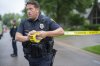 Brooklyn Park Police Lieutenant Hjelm sets up a perimeter with police tape near the scene of a shooting in Brooklyn Park, Minn. on Saturday, June 14, 2025. (Alex Kormann/Star Tribune via AP)
