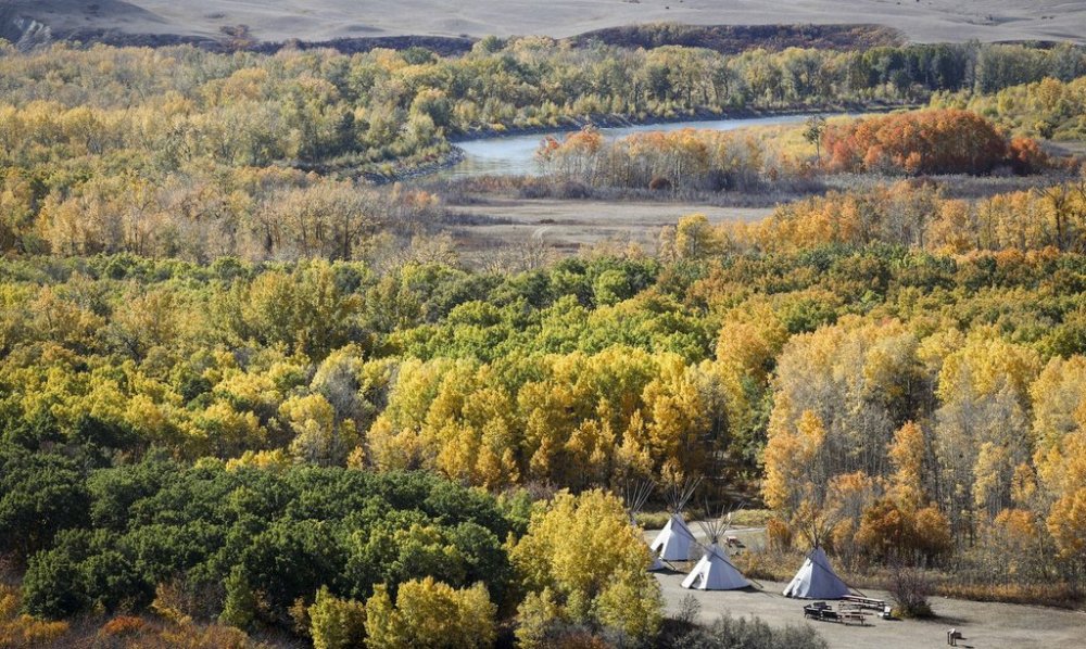 Teepees stand surrounded by fall foliage as the Bow River flows on the Siksika Nation, east of Calgary., Thursday, Sept. 28, 2023.THE CANADIAN PRESS/Jeff McIntosh<