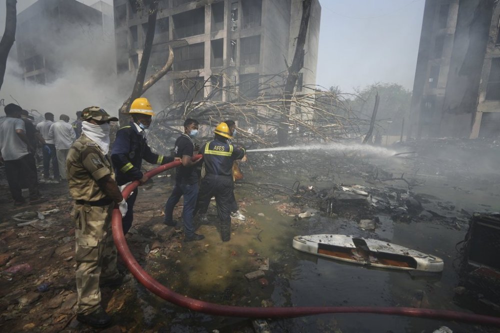 Firefighters work at the site of an airplane that crashed in India's northwestern city of Ahmedabad in Gujarat state, Thursday, June 12, 2025. (AP Photo/Ajit Solanki)