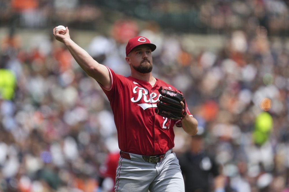 Cincinnati Reds pitcher Graham Ashcraft (23) throws to first base for an out on a Detroit Tigers' Parker Meadows bunt in the seventh inning during a baseball game, Sunday, June 15, 2025, in Detroit. (AP Photo/Paul Sancya)