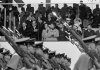FILE - President Nixon salutes as cadets from the West Point Military Academy pass the presidential reviewing stand during the inaugural parade in Washington, D.C., Jan. 20, 1969. In the front row of the reviewing stand, from left are Doug Rogers, the President, Barbara Eisenhower, Julie Nixon Eisenhower, Pat Nixon, David Eisenhower and Mamie Eisenhower. (AP Photo, File)