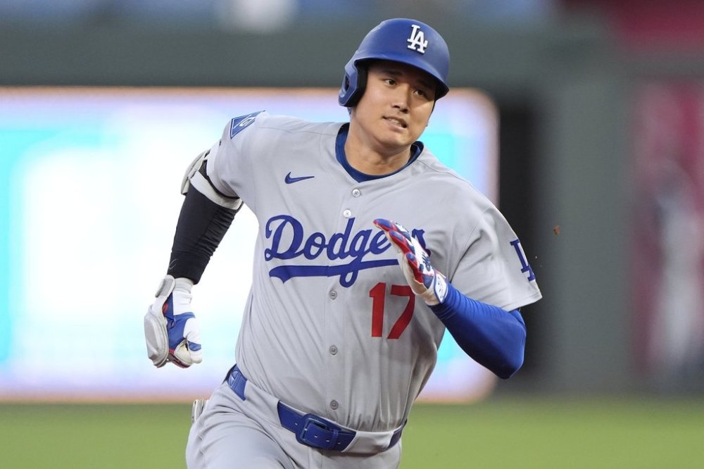 Los Angeles Dodgers' Shohei Ohtani runs to third after hitting a triple during the fifth inning of a baseball game against the Kansas City Royals, Friday, June 27, 2025, in Kansas City, Mo. (AP Photo/Charlie Riedel)