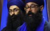 Balpreet Singh, spokesperson for the World Sikh Organization of Canada, left, looks towards Moninder Singh, spokesperson for the B.C. Gurdwaras Council and Sikh Federation Canada, as they hold a press conference on Parliament Hill in Ottawa on Thursday, June 12, 2025. THE CANADIAN PRESS/Sean Kilpatrick