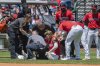 Cleveland Guardians' Gabriel Arias, sitting, is assisted after being injured during the third inning of a baseball game against the St. Louis Cardinals, Sunday, June 29, 2025, in Cleveland. (AP Photo/Phil Long)