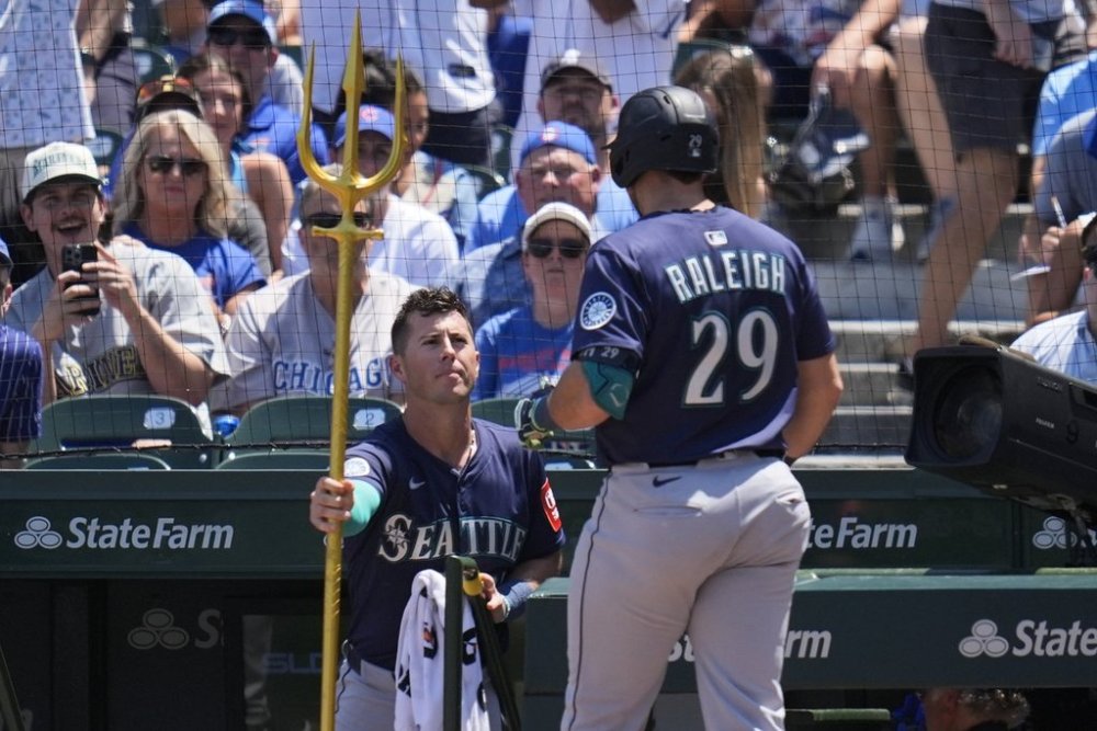 Seattle Mariners' Cal Raleigh (29), right, receives the home run trident from Dylan Moore (25) after hitting a home run during the first inning of a baseball game against the Chicago Cubs, Friday, June 20, 2025, in Chicago. (AP Photo/Erin Hooley)