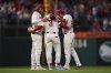 Philadelphia Phillies third baseman Alec Bohm, from left, first baseman Bryce Harper and second baseman Bryson Stott celebrate after a baseball game against the San Diego Padres Monday, June 30, 2025, in Philadelphia. (AP Photo/Matt Slocum)