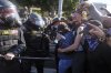Protesters confront police on the 101 Freeway near the metropolitan detention center of downtown Los Angeles, Sunday, June 8, 2025, following last night's immigration raid protest. (AP Photo/Jae C. Hong)