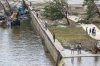 Onlookers walk along the banks of the Guadalupe River in Louise Hays Park, Saturday, July 5, 2025, in Kerrville, Texas. (AP Photo/Rodolfo Gonzalez)