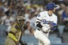 Los Angeles Dodgers' Shohei Ohtani drives in a run with a double during the third inning of a baseball game against the San Diego Padres, Monday, June 16, 2025, in Los Angeles. (AP Photo/Kyusung Gong)