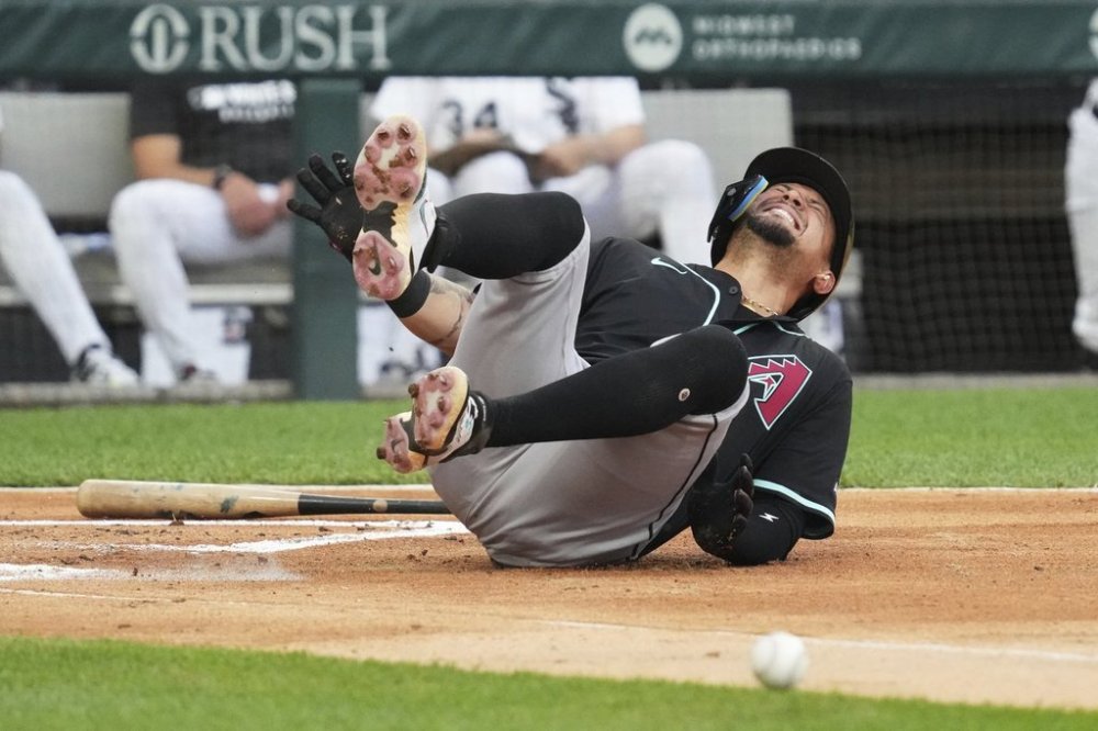 Arizona Diamondbacks' Ildemaro Vargas reacts after hit by pitch from Chicago White Sox relief pitcher Mike Vasil during the second inning of a baseball game in Chicago, Tuesday, June 24, 2025. (AP Photo/Nam Y. Huh)