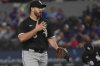CORRECTS TO AARON CIVALE NOT AARON CIVALEL - Chicago White Sox starting pitcher Aaron Civale reacts after a play during the first inning of a baseball game against the Texas Rangers, Sunday, June 15, 2025, in Arlington, Texas. (AP Photo/LM Otero)