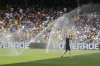 Auckland City's Gerard Garriga cools off under the sprinklers during a water break in the Club World Cup Group C soccer match between Auckland City and Boca Juniors in Nashville, Tenn., Tuesday, June 24, 2025. (AP Photo/George Walker IV)