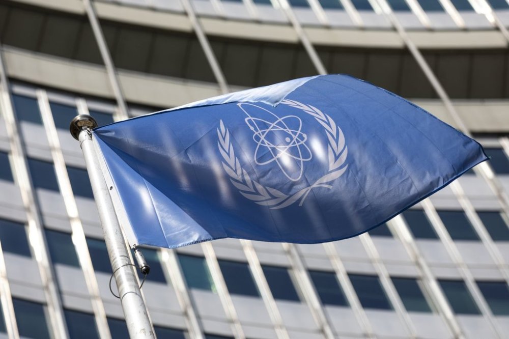 FILE - In this June 7, 2021, file photo, the flag of the International Atomic Energy Agency (IAEA) waves at the entrance of the Vienna International Center in Vienna. (AP Photo/Lisa Leutner, File)