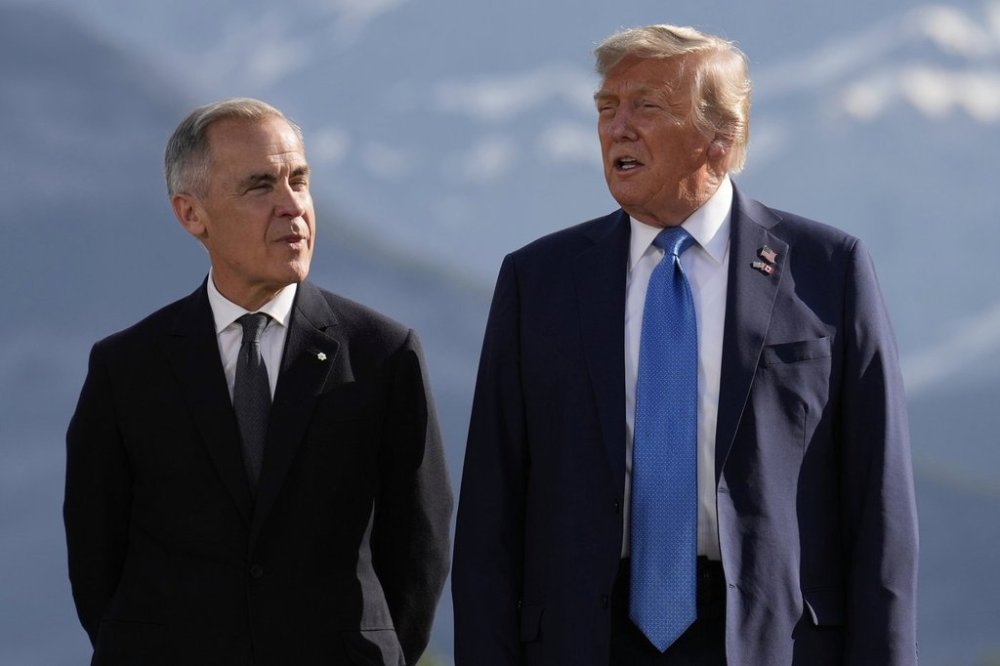 Canada's Prime Minister Mark Carney, listens as President Donald Trump speaks during a group photo at the G7 Summit, Monday, June 16, 2025, in Kananaskis, Canada. (AP Photo/Mark Schiefelbein)