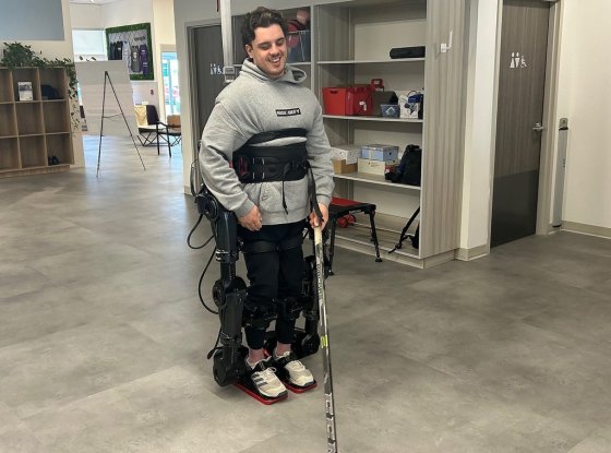 Former Humboldt Bronco Ryan Straschnitzki walks using a new exoskeleton in Calgary on Thursday. (Bill Graveland / The Canadian Press)