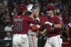 Arizona Diamondbacks' Jake McCarthy celebrates with Eugenio Suarez (28) after hitting a three-run home run against the San Francisco Giants in the fourth inning during a baseball game, Tuesday, July 1, 2025, in Phoenix. (AP Photo/Rick Scuteri)