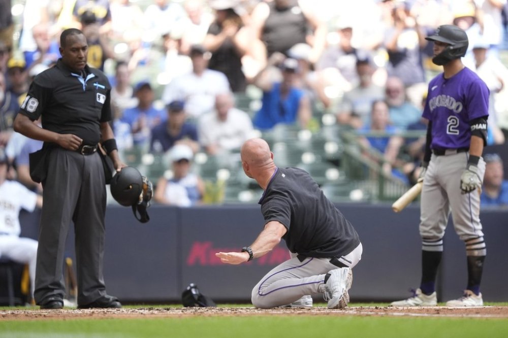 Colorado Rockies interim manager Warren Schaeffer, middle, gestures to an umpire after being ejected during the third inning of a baseball game against the Milwaukee Brewers, Sunday, June 29, 2025, in Milwaukee. (AP Photo/Aaron Gash)