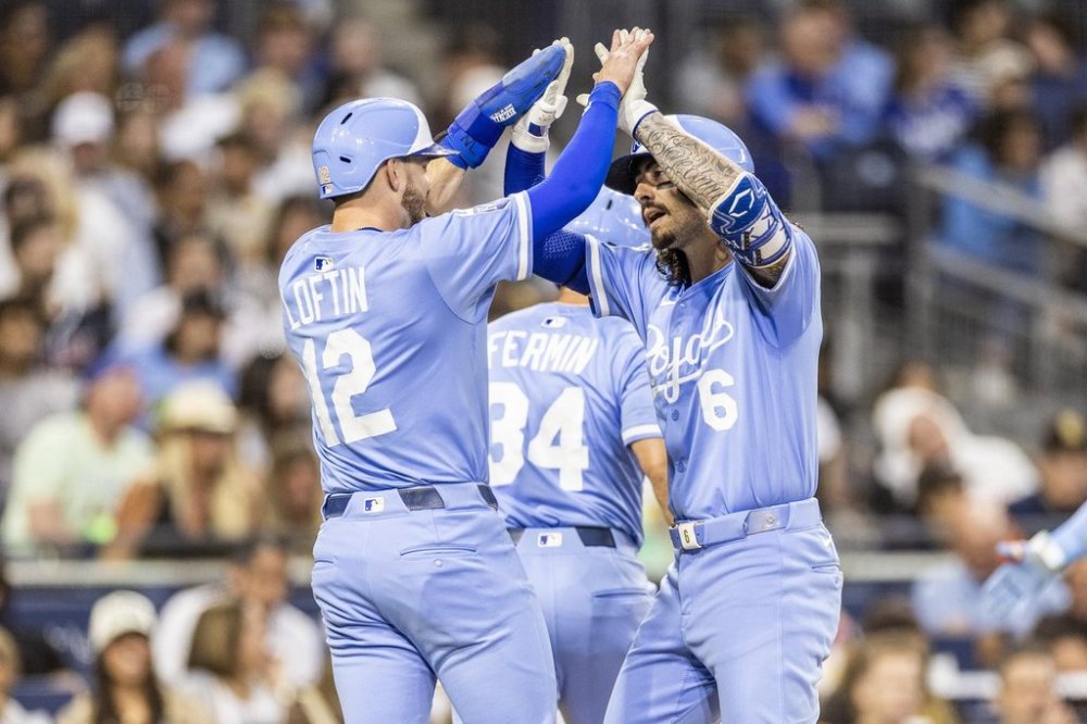 Kansas City Royals' Nick Loftin (12) celebrates after a home run by Jonathan India (6) in the fifth inning of a baseball game against the San Diego Padres, Friday, June 20, 2025, in San Diego. (AP Photo/Tony Ding)