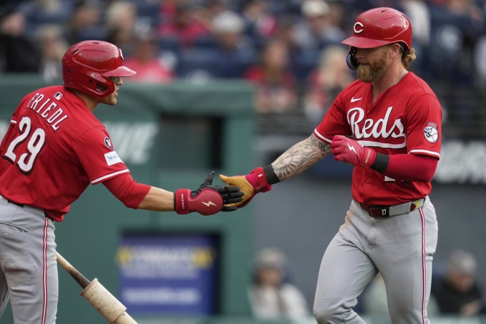 Cincinnati Reds' Jake Fraley, right, is congratulated by teammate TJ Friedl (29) after hitting a home run in the fourth inning of a baseball game against the Cleveland Guardians in Cleveland, Monday, June 9, 2025. (AP Photo/Sue Ogrocki)