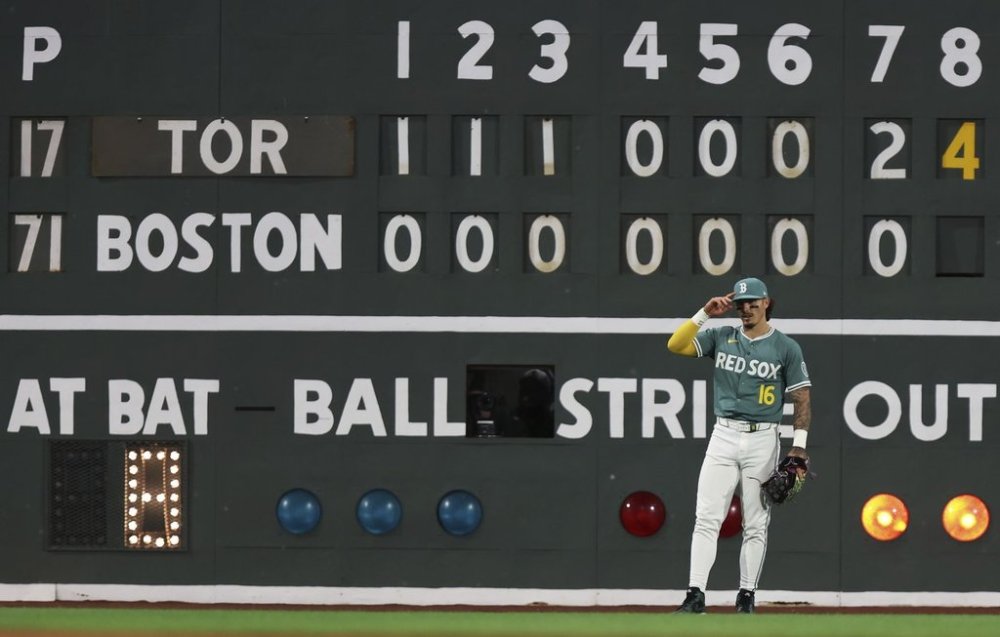 Boston Red Sox left fielder Jarren Duran stands in front of the scoreboard after the Toronto Blue Jays scored a run in the eighth inning of a baseball game Friday, June 27, 2025, in Boston. (AP/Photo/Jim Davis)