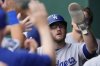 Los Angeles Dodgers' Max Muncy celebrates in the dugout after scoring on a single by Miguel Rojas during the seventh inning of a baseball game against the Kansas City Royals, Sunday, June 29, 2025, in Kansas City, Mo. (AP Photo/Charlie Riedel)