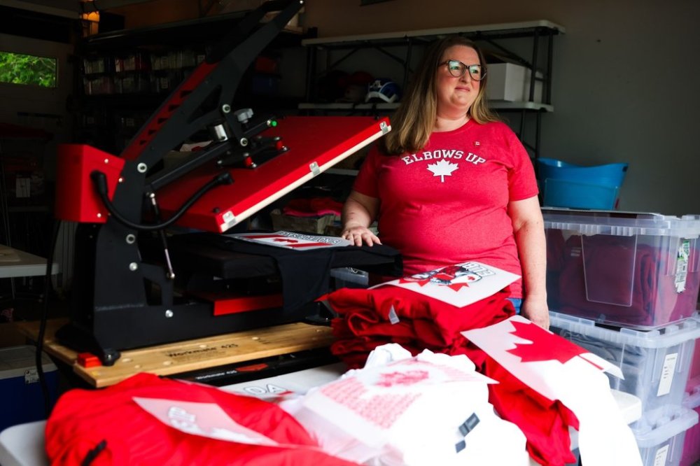 Stephanie Tomlin stands for a portrait in her workspace where she prints Canadian-themed apparel, in Toronto, Friday, June 20, 2025. THE CANADIAN PRESS/Cole Burston