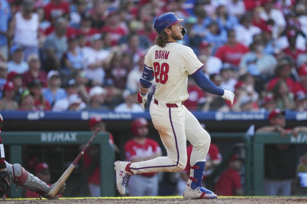 Philadelphia Phillies' Alec Bohm watches his two-run home run off Cincinnati Reds pitcher Nick Lodolo during the sixth inning of a baseball game, Saturday, July 5, 2025, in Philadelphia. (AP Photo/Derik Hamilton)