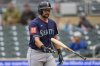 Seattle Mariners' Cal Raleigh walks back to the dugout after striking out during the fourth inning of a baseball game against the Minnesota Twins, Thursday, June 26, 2025, in Minneapolis. (AP Photo/Abbie Parr)