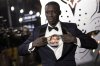 FILE - Khaby Lame opens his shirt to reveal the image of Chadwick Boseman upon arrival for the premiere of the film 'Black Panther: Wakanda Forever' in London, Nov. 3, 2022. (Photo by Vianney Le Caer/Invision/AP File)