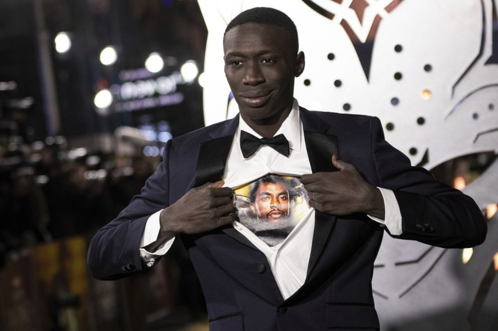 FILE - Khaby Lame opens his shirt to reveal the image of Chadwick Boseman upon arrival for the premiere of the film 'Black Panther: Wakanda Forever' in London, Nov. 3, 2022. (Photo by Vianney Le Caer/Invision/AP File)