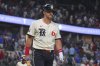 Texas Rangers' Josh Jung walks to the dugout after striking out, ending the 12th inning of a baseball game against the Seattle Mariners, Friday, June 27, 2025, in Arlington, Texas. (AP Photo/LM Otero)