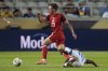 El Salvador's Santos Ortiz (12) trips up Canada's Niko Sigur (23) during a CONCACAF Gold Cup soccer match in Houston, Tuesday, June 24, 2025. THE CANADIAN PRESS/AP, Ashley Landis