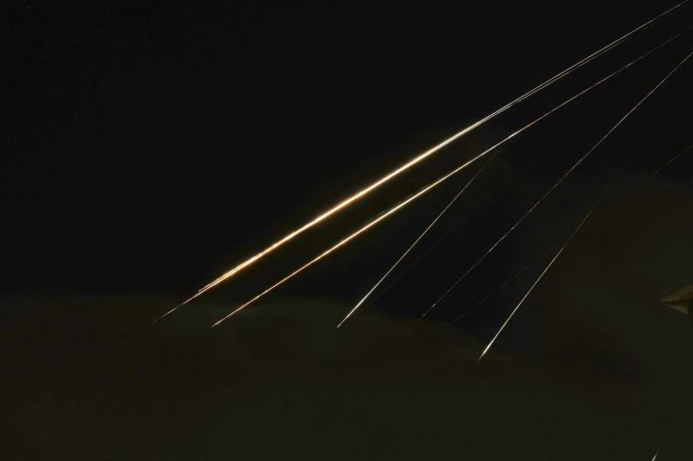Traces of projectile illuminates the sky seen from northern Israel, Saturday, June 14, 2025. (AP Photo/Ariel Schalit)