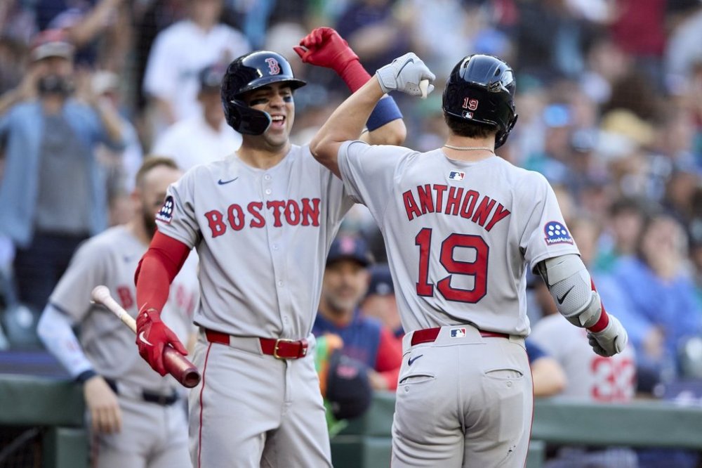 Boston Red Sox's Roman Anthony (19) is greeted by Marcelo Mayer, left, after hitting a solo home run off Seattle Mariners starting pitcher Logan Gilbert during the first inning of a baseball game Monday, June 16, 2025, in Seattle. (AP Photo/John Froschauer)