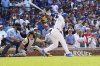Chicago Cubs' Ian Happ, right, hits a walkoff single against the Pittsburgh Pirates during the 10th inning of a baseball game Sunday, June 15, 2025, in Chicago. (AP Photo/David Banks)