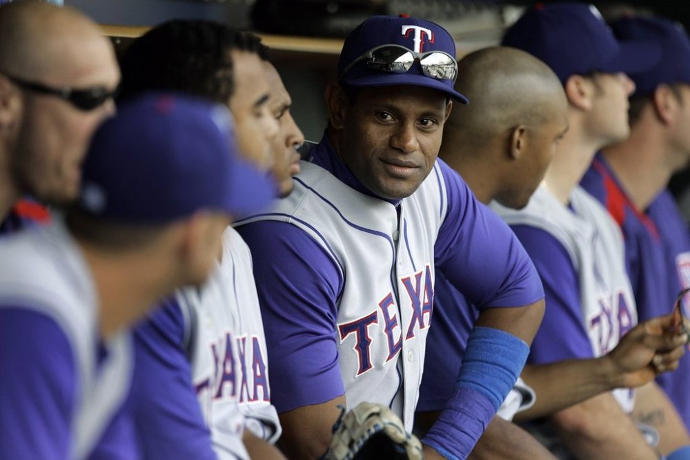 FILE - Texas Rangers' Sammy Sosa sits on the bench against the Detroit Tigers in the ninth inning of the first game of a Major League Baseball doubleheader in Detroit, Sept. 11, 2007. (AP Photo/Paul Sancya, File)