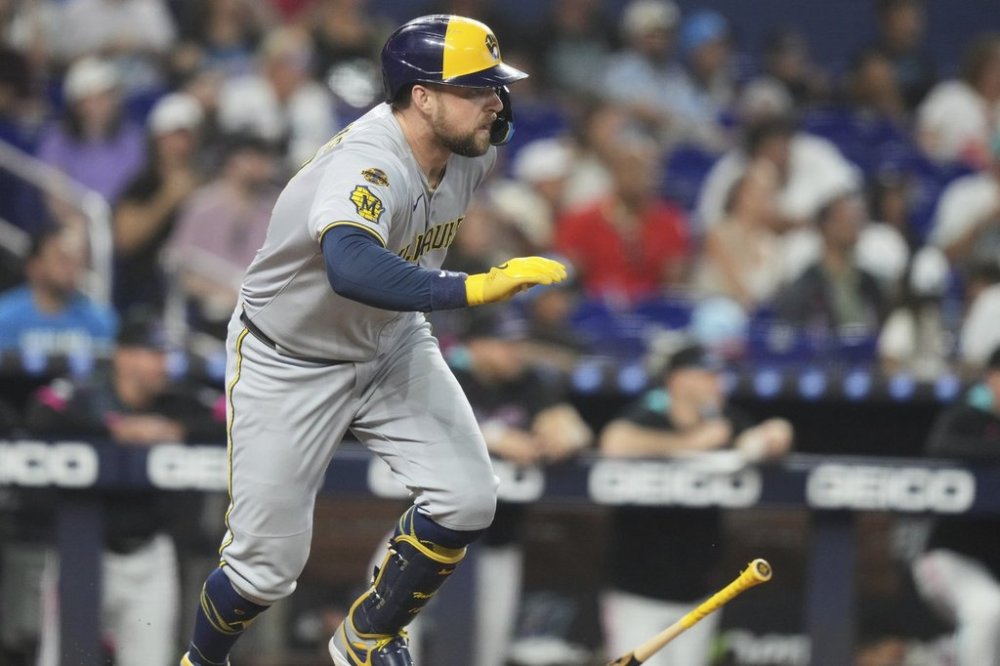 Milwaukee Brewers' Rhys Hoskins runs after hitting a RBI triple to score Jackson Chourio during the second inning of a baseball game against the Miami Marlins, Saturday, July 5, 2025, in Miami. (AP Photo/Lynne Sladky)