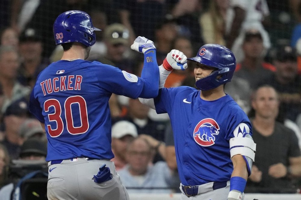 Chicago Cubs' Kyle Tucker (30) celebrates with designated hitter Seiya Suzuki after hitting a home run during the fourth inning of a baseball game against the Houston Astros in Houston, Saturday, June 28, 2025. Reese McGuire and Ian Happ also scored. (AP Photo/Ashley Landis)