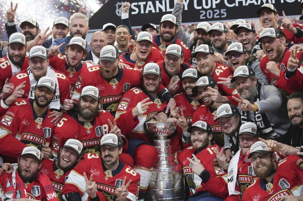 The Florida Panthers team poses with the Stanley Cup trophy after defeating the Edmonton Oilers in Game 6 of the NHL hockey Stanley Cup Final Tuesday, June 17, 2025, in Sunrise, Fla. (AP Photo/Lynne Sladky)