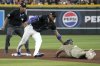 Arizona Diamondbacks second baseman Ketel Marte, center, tags out San Diego Padres' Jackson Merrill, right, who was trying to steal second in the seventh inning during a baseball game, Saturday, June 14, 2025, in Phoenix. (AP Photo/Rick Scuteri)