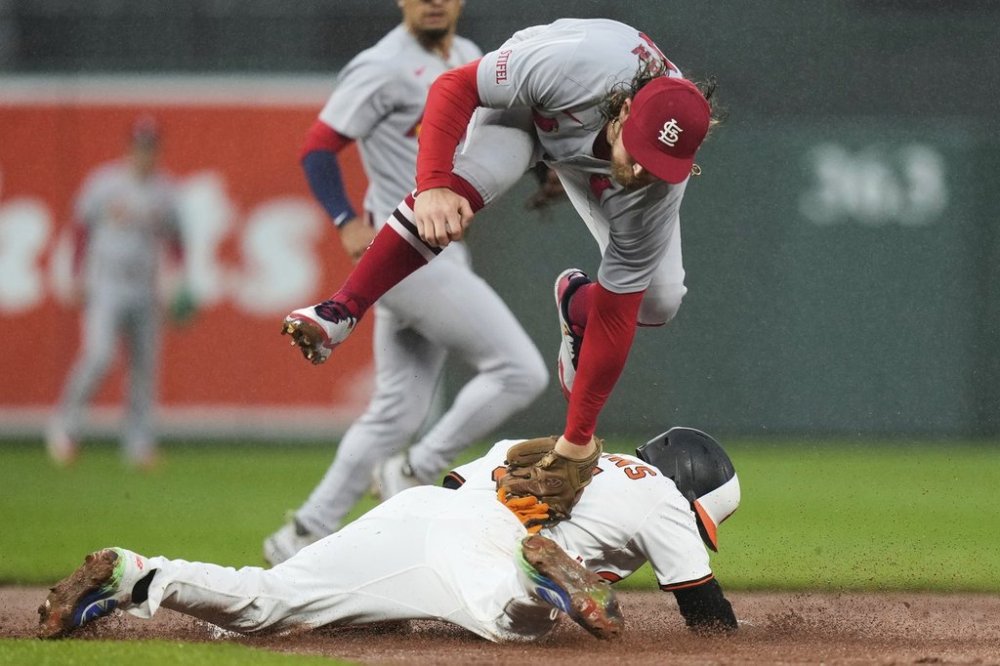 Baltimore Orioles' Cedric Mullins, below, steals second base in front of St. Louis Cardinals second baseman Brendan Donovan during the second inning of a baseball game, Wednesday, May 28, 2025, in Baltimore. (AP Photo/Stephanie Scarbrough)