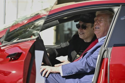 FILE - President Donald Trump and Tesla CEO Elon Musk speak to reporters as they sit in a red Model S Tesla vehicle on the South Lawn of the White House, March 11, 2025, in Washington. (Pool via AP, File)