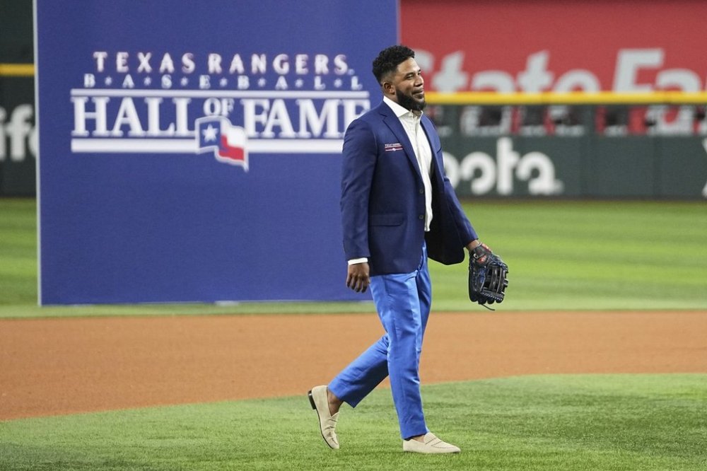 Former Texas Rangers player Elvis Andrus walks across the field during a ceremony where Andrus was inducted into the clubs hall of fame before a baseball game against the Seattle Mariners Saturday, June 28, 2025, in Arlington, Texas. (AP Photo/Tony Gutierrez)